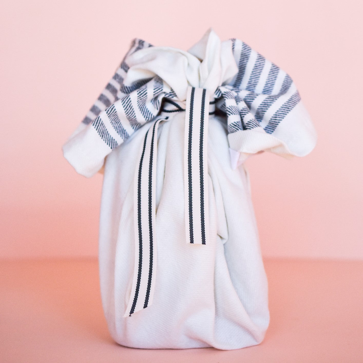 the small gift set wrapped in a Turkish towel and tied with a ribbon