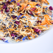 Closeup of dried flower petals in gold, burgundy and bright blue