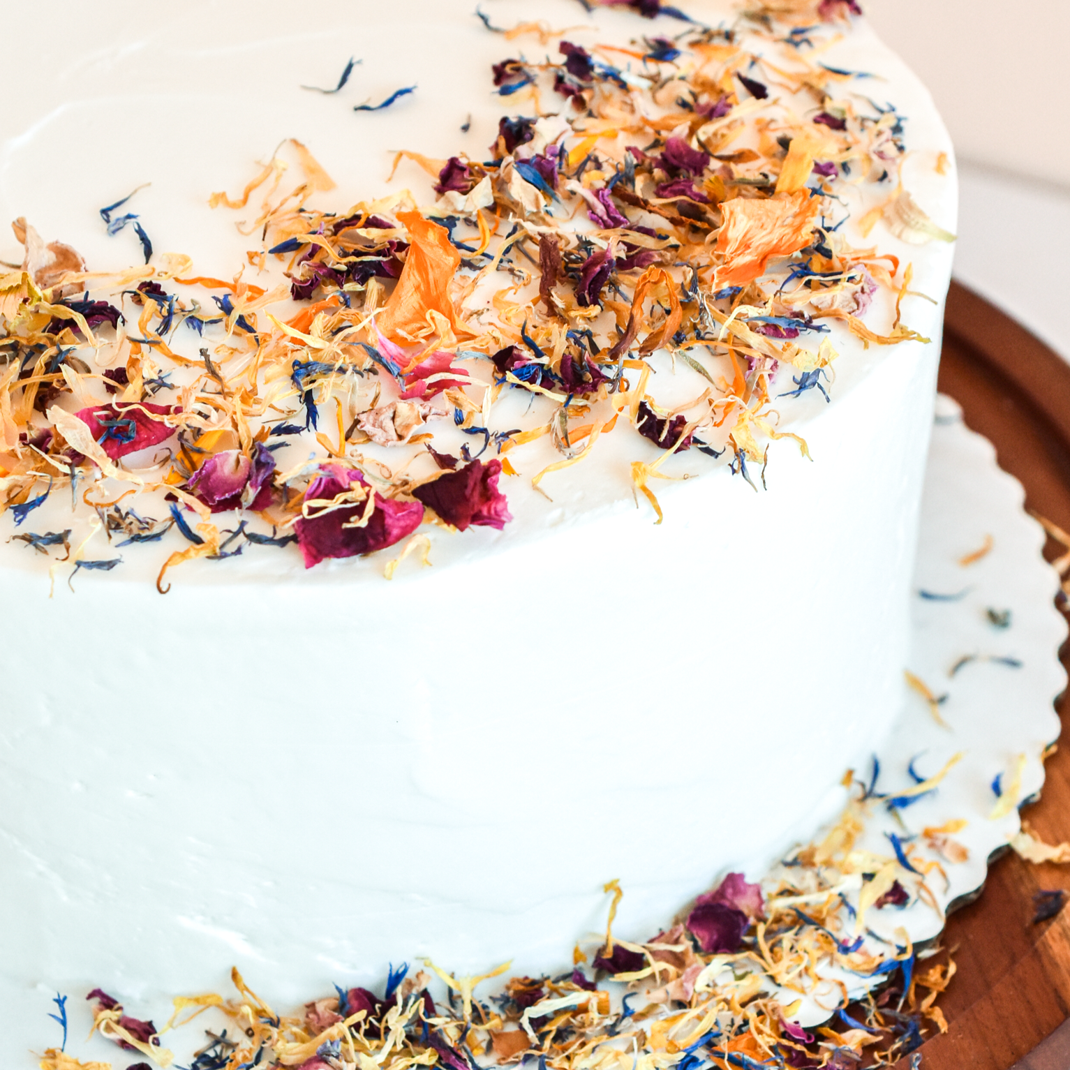 A plain white cake made more interesting with a scattering of flowerfetti on top