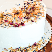 A plain white cake made more interesting with a scattering of flowerfetti on top