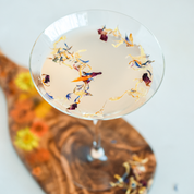 A drink topped with flowerfetti dried flower petals